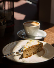 Piece of cake and cup of coffee. on table.