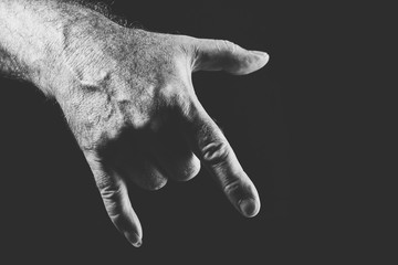 hand showing a cool gesture, in black and white