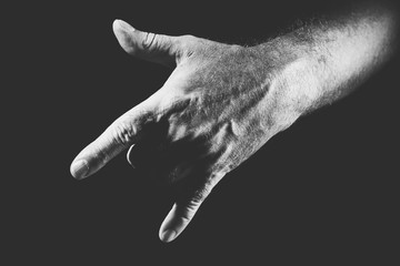 hand showing a cool gesture, in black and white