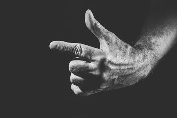hand showing one direction, in black and white