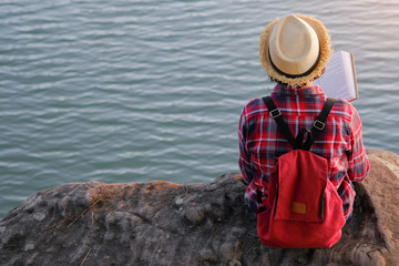 Pretty relaxed young woman reading a book in quiet nature, concept read a books.