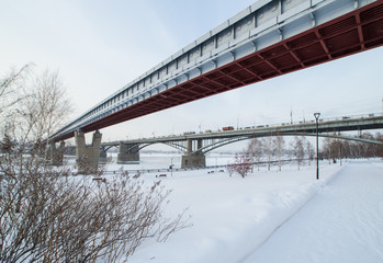 Bridges over the river and the embankment covered with snow in winter