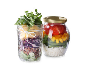 Glass jars with healthy meal isolated on white
