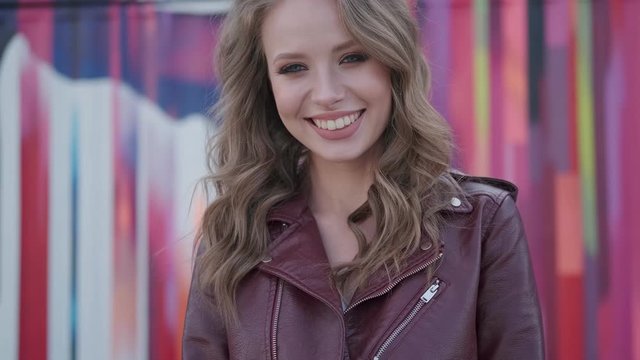 Portrait of a cute girl with a charming prepossessing smile. young woman looking at camera and smiling.
