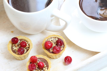 Fruit cupcakes with hazelnuts on a white background