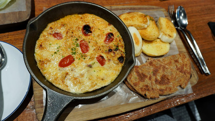 creamy chicken enchilada casserole and Bread on wooden table.  Italian food