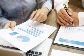 Business team brainstorming and discussing with financial data and report graph. Teamwork meeting working concept.