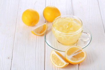 Still life with lemon, ginger and honey on a white background