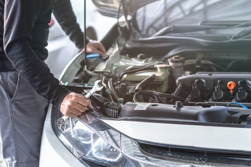 Hand of mechanic man hold spanner tool, inspection and mentenance car service