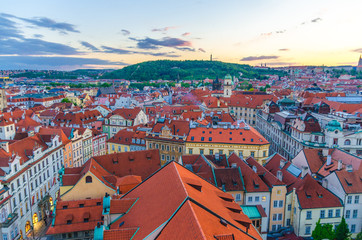 Fototapeta na wymiar Top aerial panoramic view of Prague Old Town (Stare Mesto) historical city centre with red tiled roof buildings and Petrin hill garden in evening sunset, Bohemia, Czech Republic