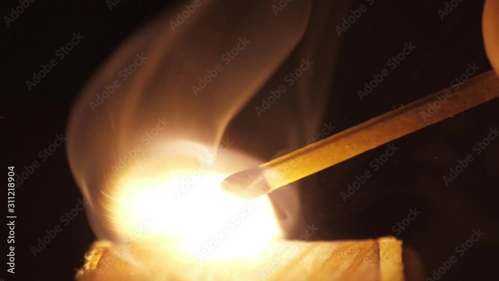 Wall mural lighting a match macro shot slow motion