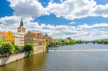 Fototapeta na wymiar Bedrich Smetana Museum on the bank of Vltava river in Prague old town historical city center, view from Charles Bridge Karluv Most, blue sky white clouds background, Bohemia, Czech Republic