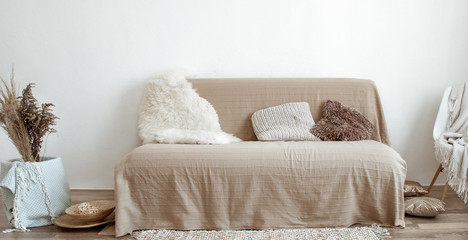 The interior of the living room with a sofa and decorative items.