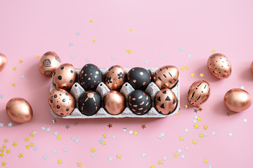 Festive painted Easter eggs on pink background.