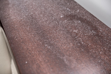 A lot of dust on wooden polished surface of furniture, dusty home concept