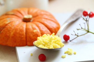 Walking porridge with pumpkin and milk on a white background