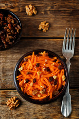 Carrot walnut raisin salad with glass of water
