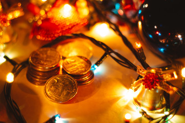 Close up shot of  Serbian money in coins surrounded with Christmas decoration. Serbian money, Christmas bell and colorful lights.