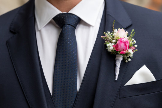 groom with wedding bouquet of flowers