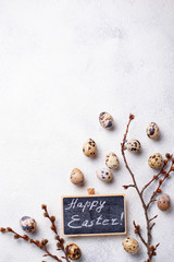 Easter background with quail eggs and pussy willow