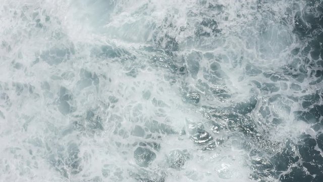 Aerial view of big waves foaming and splashing in sea, Sunny day. Island Bali, Indonesia. Indian ocean.