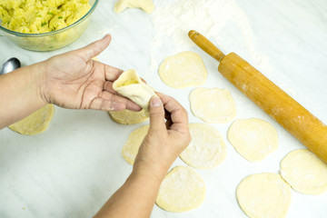 We cook the filling, knead the dough, sculpt the dumplings. Selective focus.