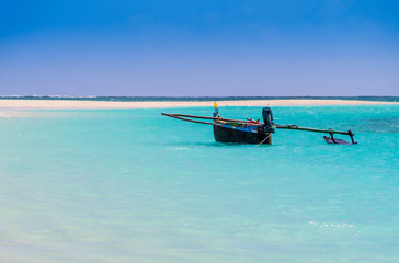 Colored outrigger fishermen pirogue moored on turquoise sea of Nosy Ve island, Indian Ocean, Madagascar