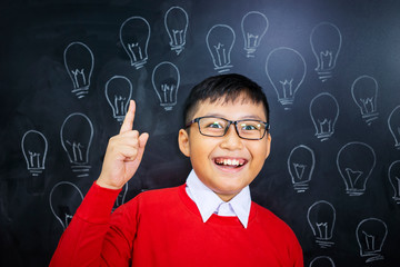 Closeup of an adorable Asian boy realizing an idea