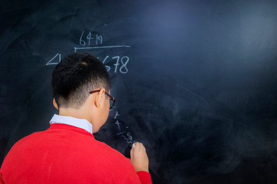 Closeup of an adorable boy solving calculations - Powered by Adobe