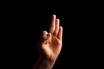 Hand Showing Sign of F Alphabet in American Sign Language (ASL), isolated on black background. Sign language