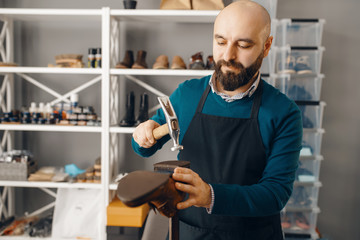 Shoemaker knocks the heel, shoe repair service