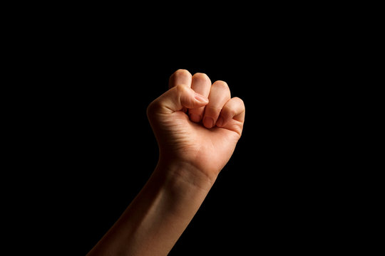 Hand Showing Sign of E Alphabet in American Sign Language (ASL), isolated on black background. Sign language