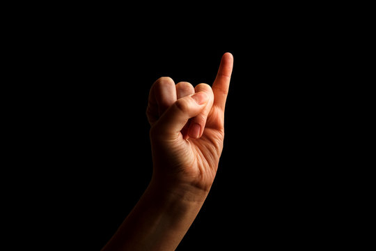 Hand Showing Sign of I Alphabet in American Sign Language (ASL), isolated on black background. Sign language