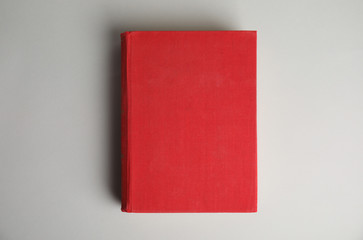 Hardcover book on light grey background, top view. Space for design