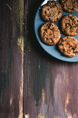 Chocolate cookies on wooden table. Chocolate chip cookies shot on black