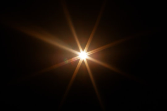 Easy to add lens flare effects for overlay designs or screen blending mode to make high-quality images. Abstract sun burst, digital flare, iridescent glare over black background.