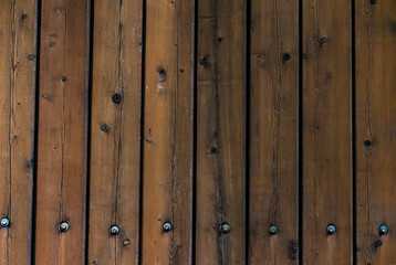 wooden brown bars with large iron bolts hammered into them