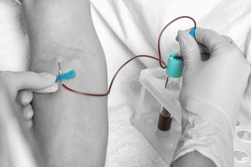 Cosmetologist does prp therapy on the face of a beautiful woman in a beauty salon. There is in vitro  blood plasma, ready for injection. Cosmetology concept.