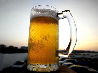 bubbles in the beer in the glass. the beer is poured into a beer glass and it flows in foam in a glass