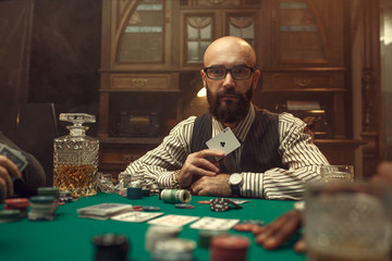 Bearded poker player show ace card, casino