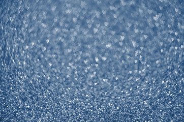 Classic Blue color. Color of the year 2020. Abstract festive bokeh background with shining defocus sparkles. Blurred glitters shimmering dust macro close up, copy space for text logo