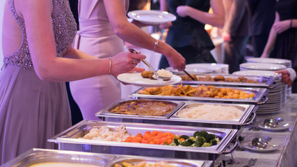 Obraz na płótnie Canvas buffet, guests put food in the dish