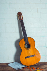 Fototapeta na wymiar guitar in wooden background