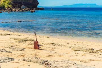 Guitar on the sandy beach, Fiji.