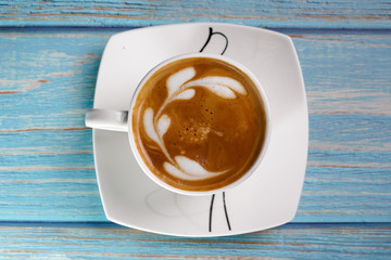 cup of coffee on wooden table