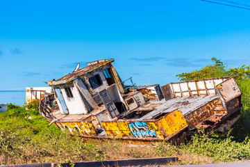 Rusty, old ship lies on the shore, Galapagos Island, Isla Isabela. Copy space for text.