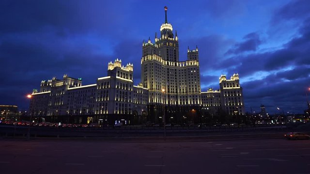 Moscow cityscape at winter night. Stalinist neoclassical style building on the Kotelnicheskaya embankment, road is filled by cars. 
