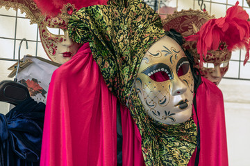 Couple standing in masks and red masquerade costumes during Venetian carnival in Annevoie  gardens, Rue des jardins, 37 a, Annevoie/ Belgium - 311239192