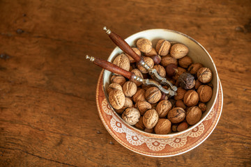 unshelled walnuts in a plate on a wooden background. view from above. place for text. - 311239929
