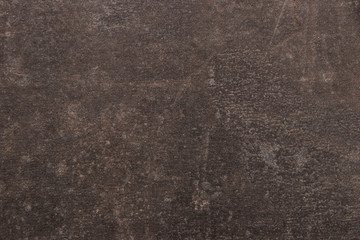 Brown and dark background with streaks, scratches and scuffs. Texture imitating the surface of a...